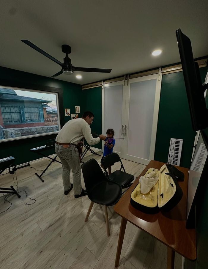Violin instructor helping student during a lesson.