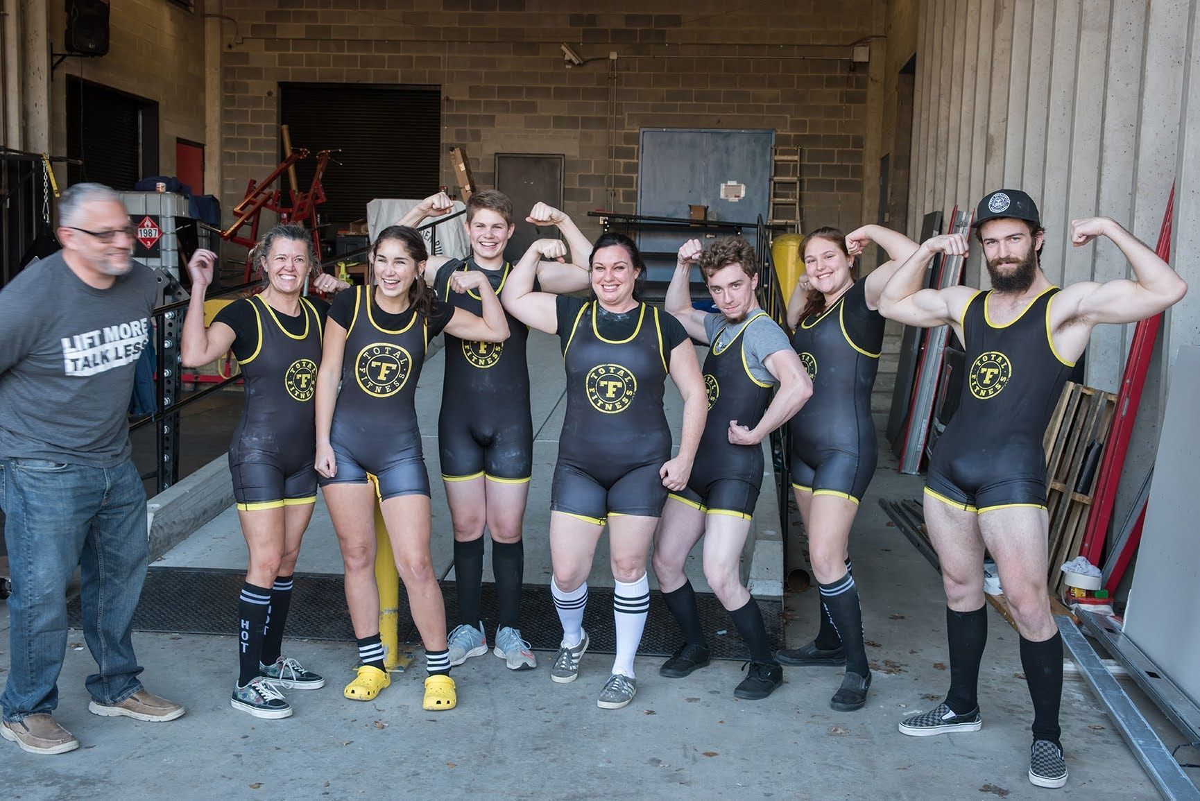 A group of people are posing for a picture and one of them is wearing a shirt that says life is good
