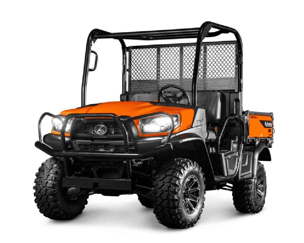 Orange and black Kubota utility vehicle with a roll cage, parked indoors.