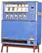 Blue vending machine with multiple selection buttons, dials, and a coin slot.