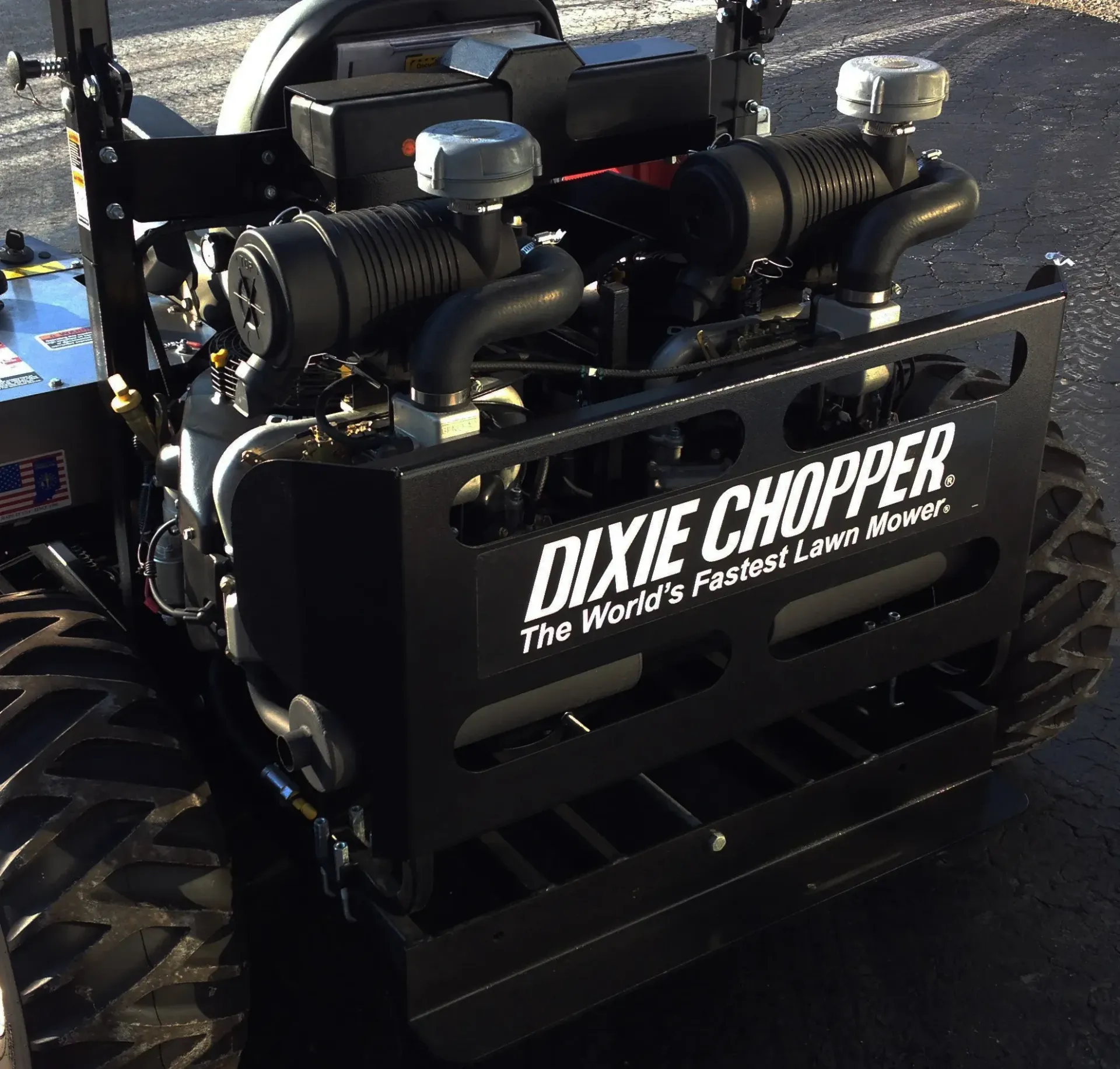 Black Dixie Chopper lawn mower with large tires, engine visible,