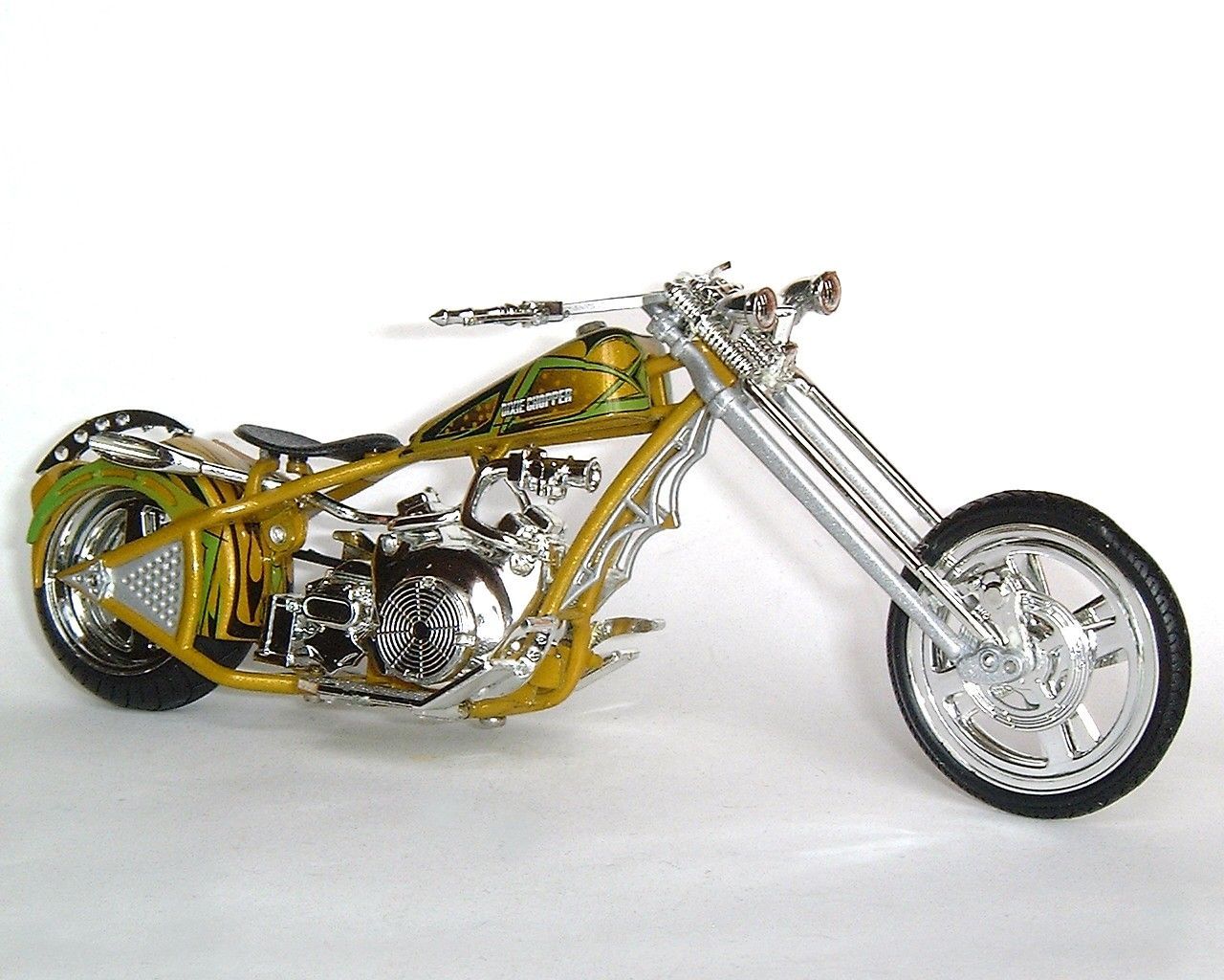 Chrome and yellow chopper motorcycle on white background.