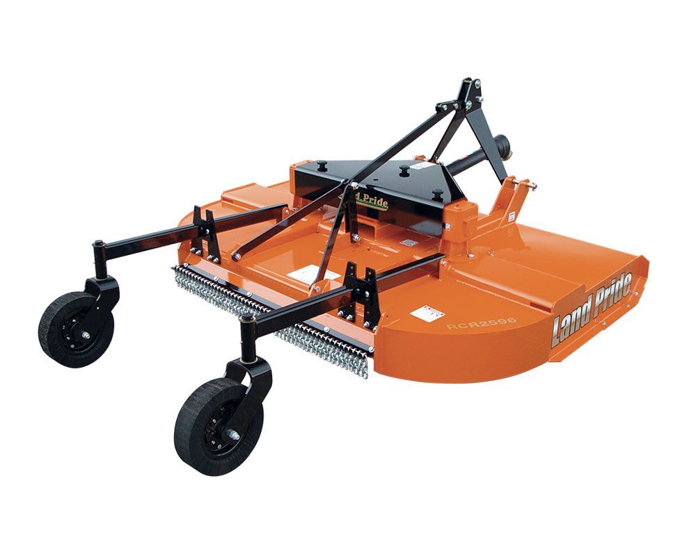 Orange rotary cutter with black wheels, attached to a tractor for mowing fields.