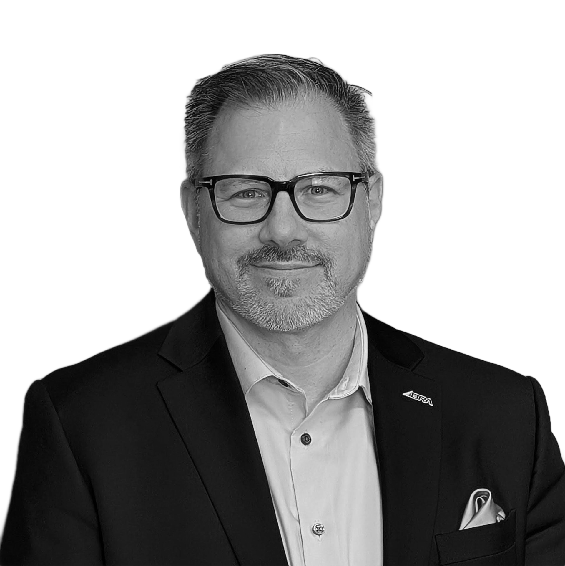Man in suit and glasses looking to the side with a slight smirk.
