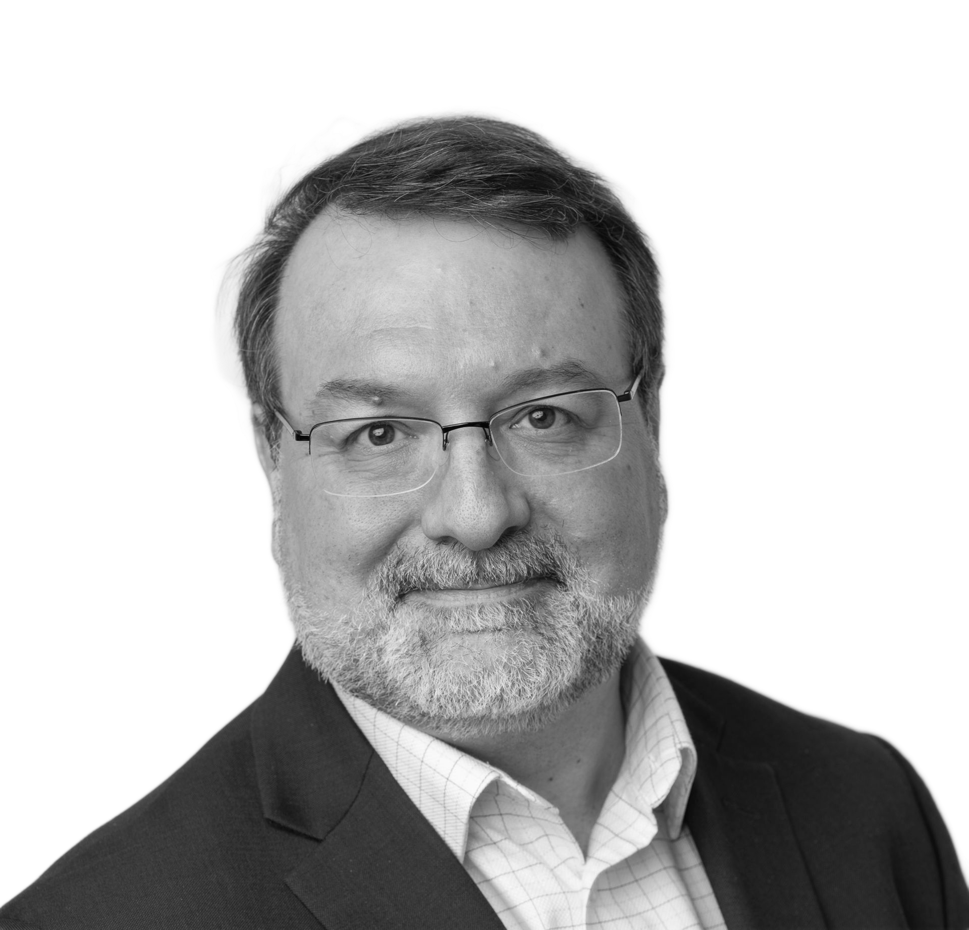 Man in a suit smiles, headshot against a white background.