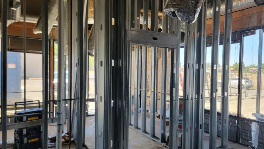 A building under construction with a lot of metal frames.