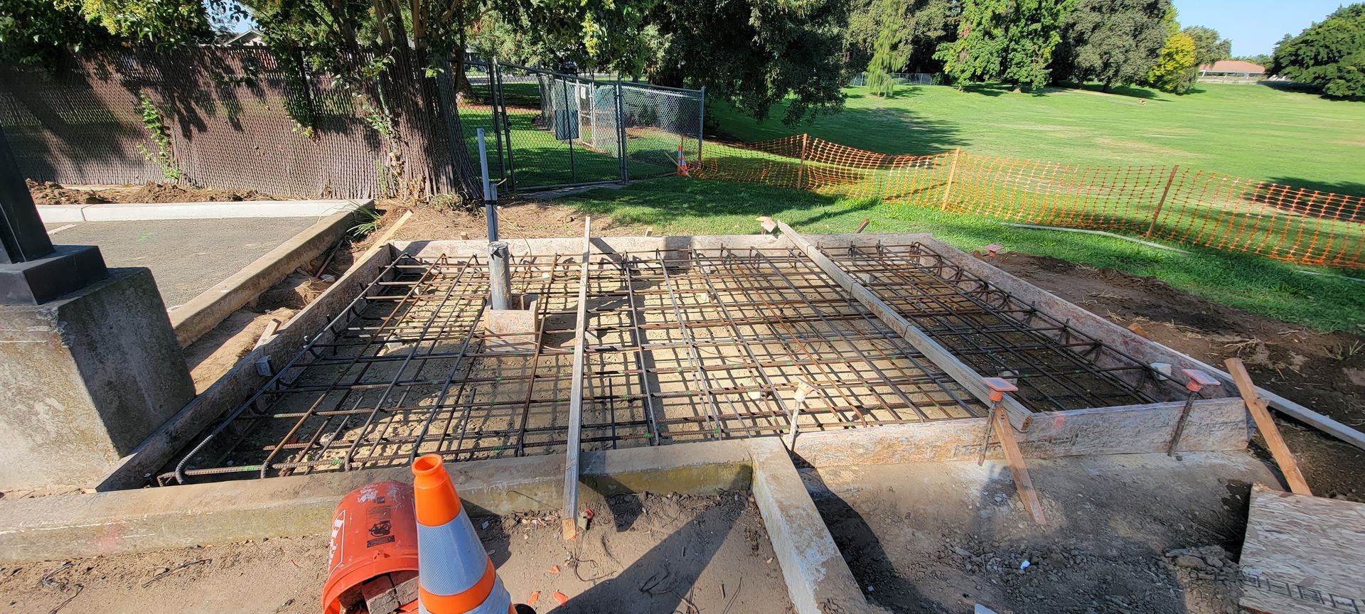 A construction site with a cone in the middle of it.