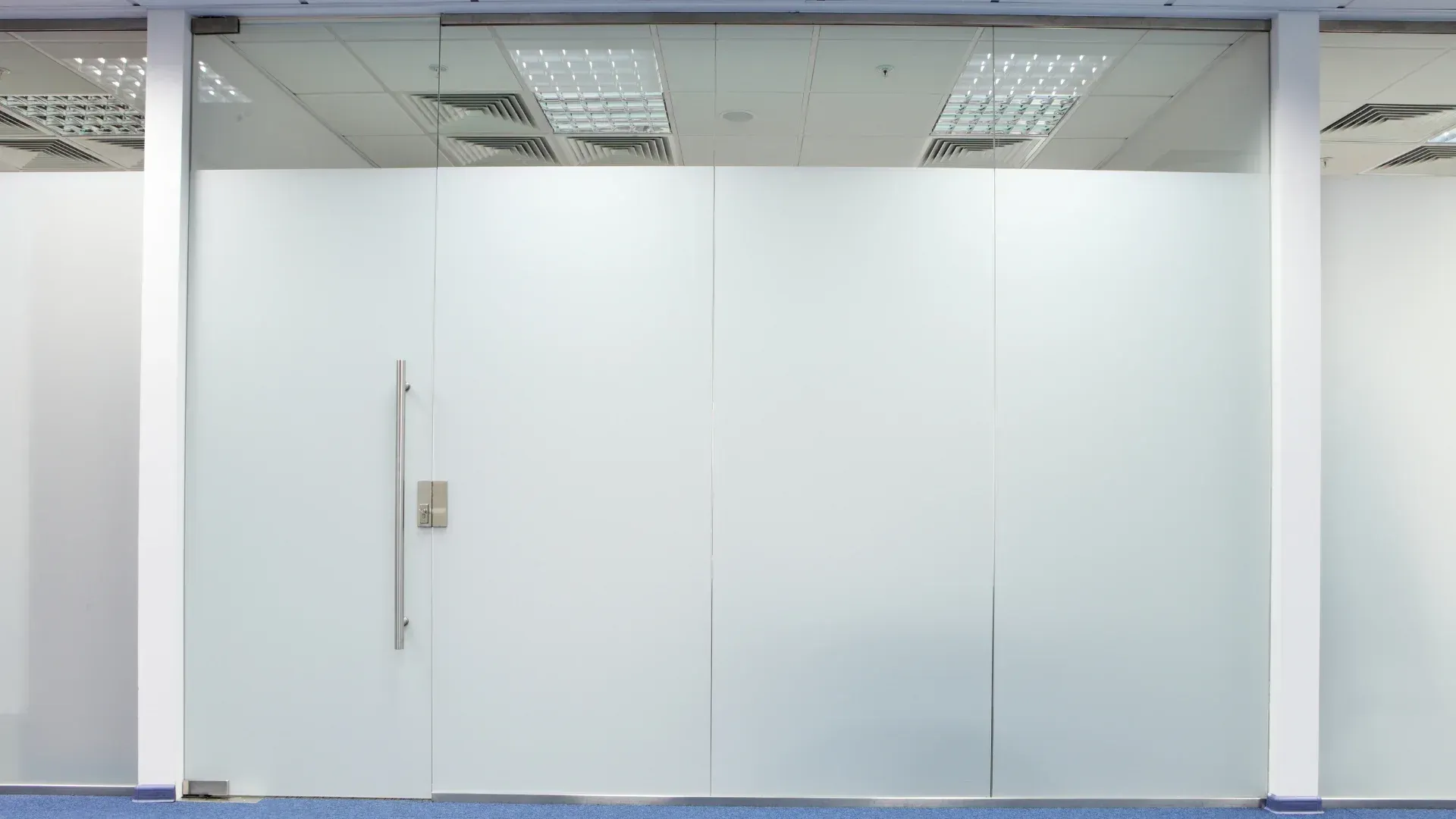 There is a glass door in the middle of the room.