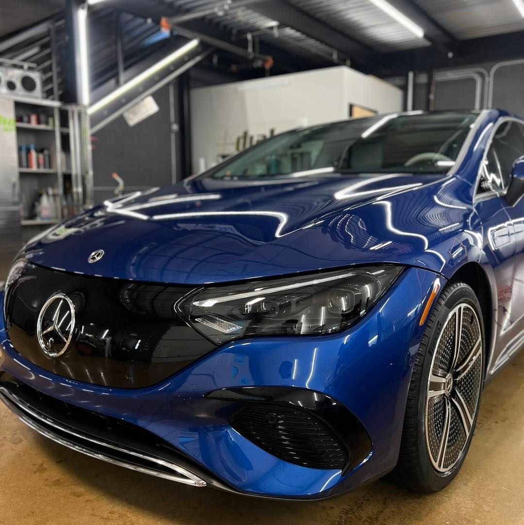 A blue car with a bmw logo on the front