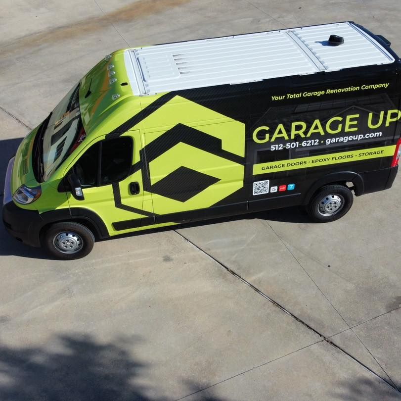 A black and yellow van says garage up on the side