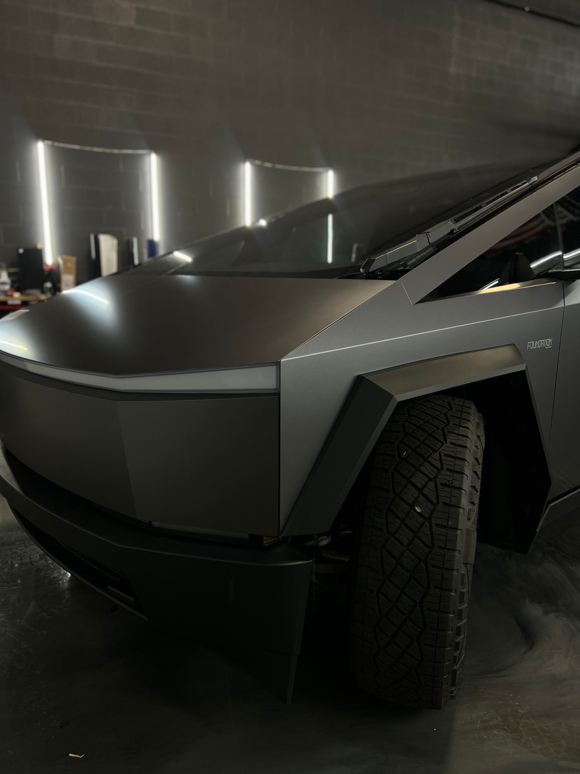 A tesla cybertruck is parked in a garage