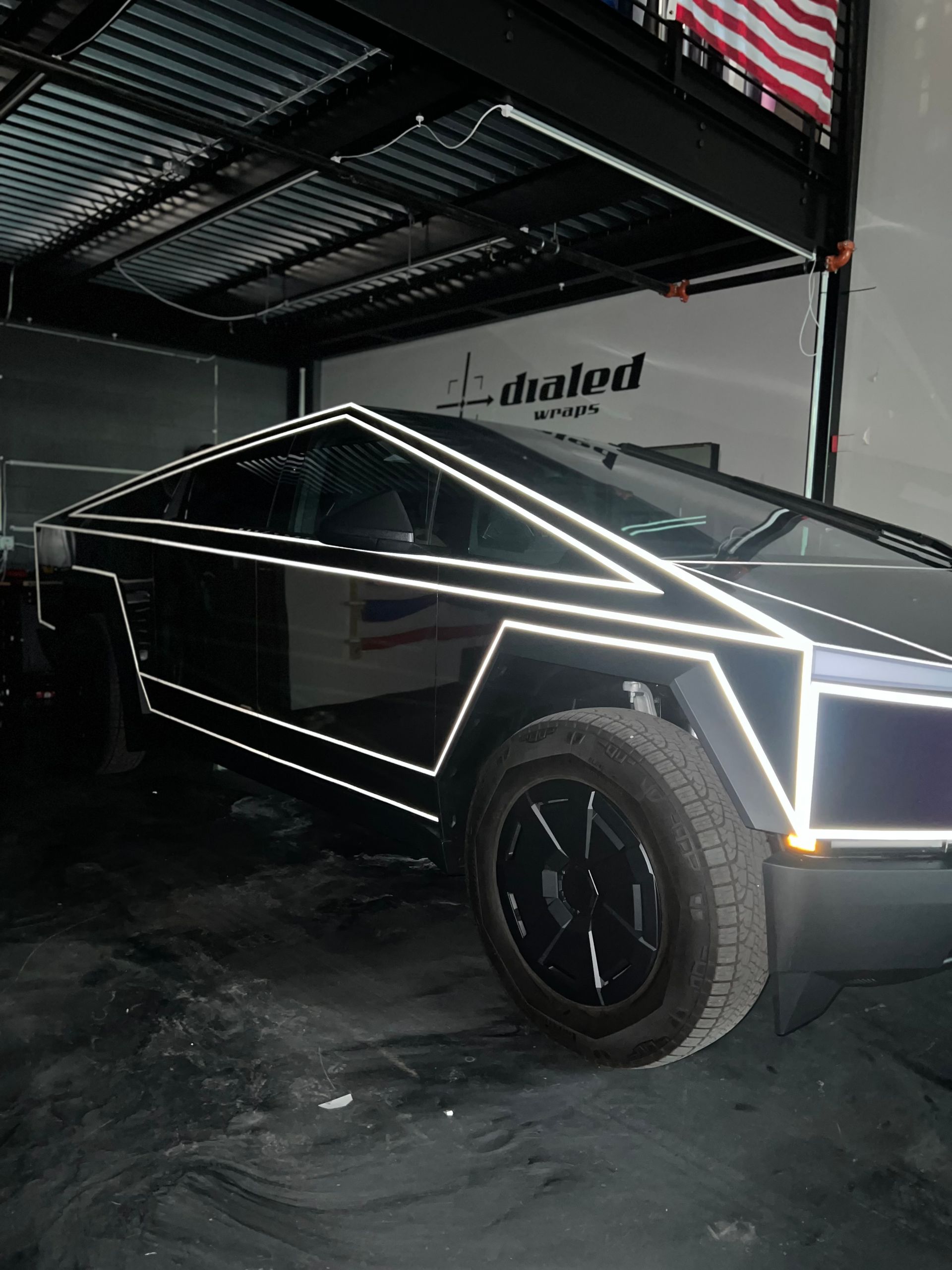 A tesla cybertruck is parked in a garage