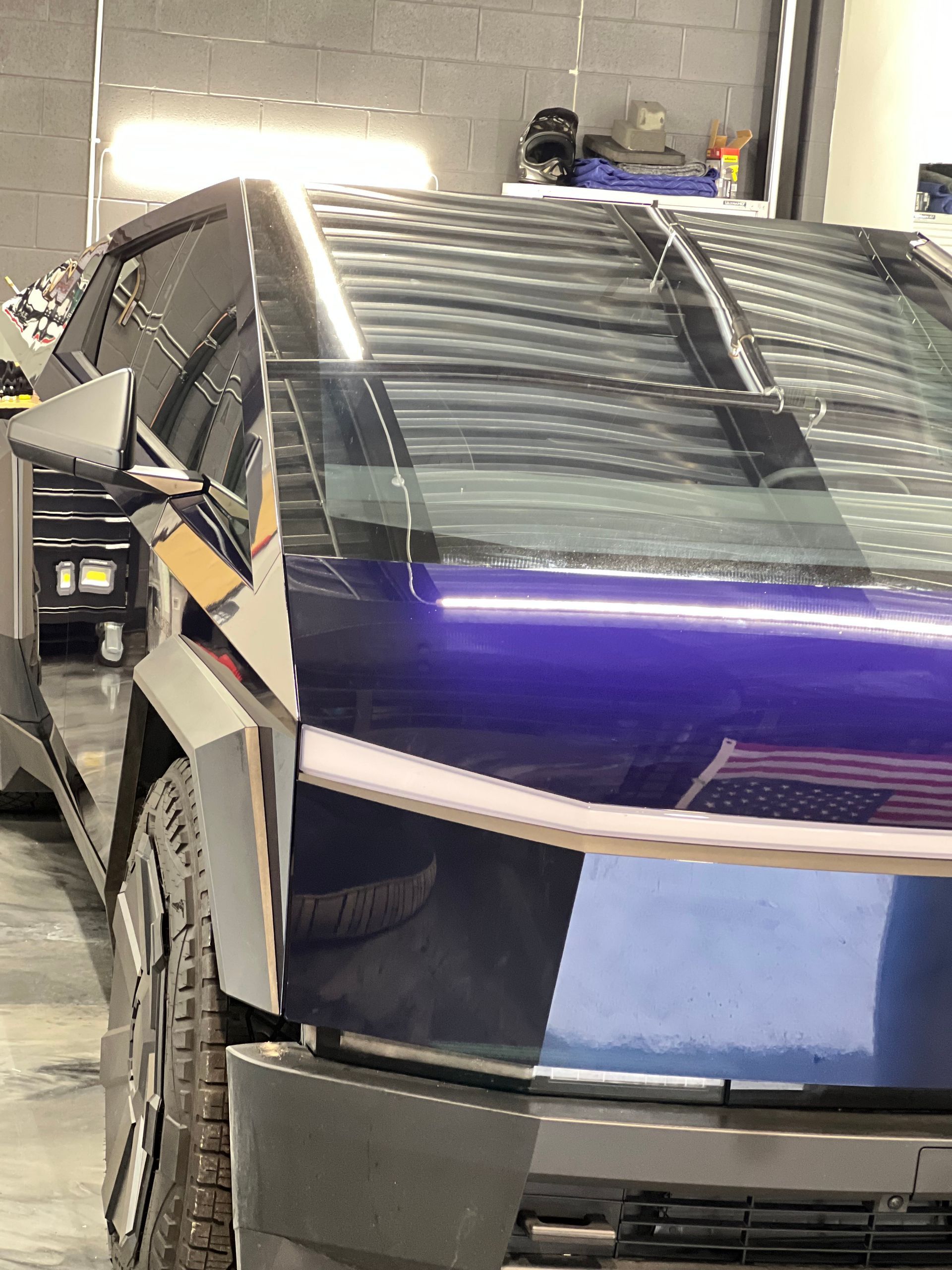 A purple car is parked in a garage.