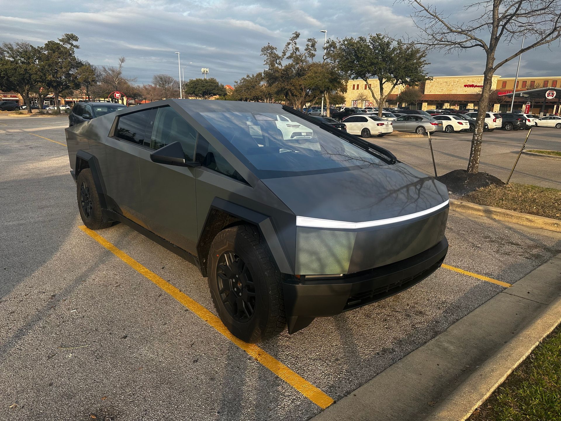A tesla cybertruck is parked in a parking lot.