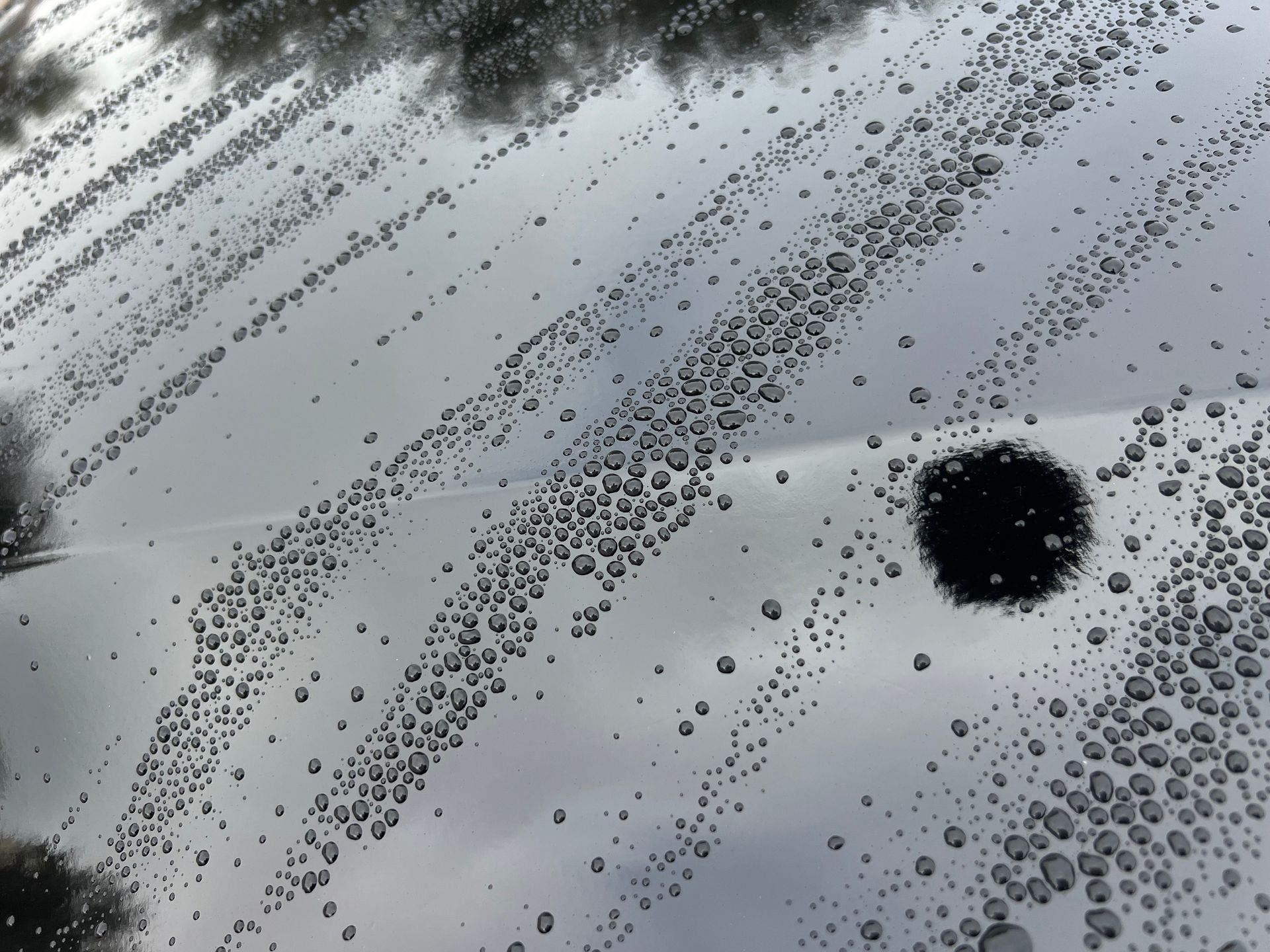 A close up of a car windshield with water drops on it