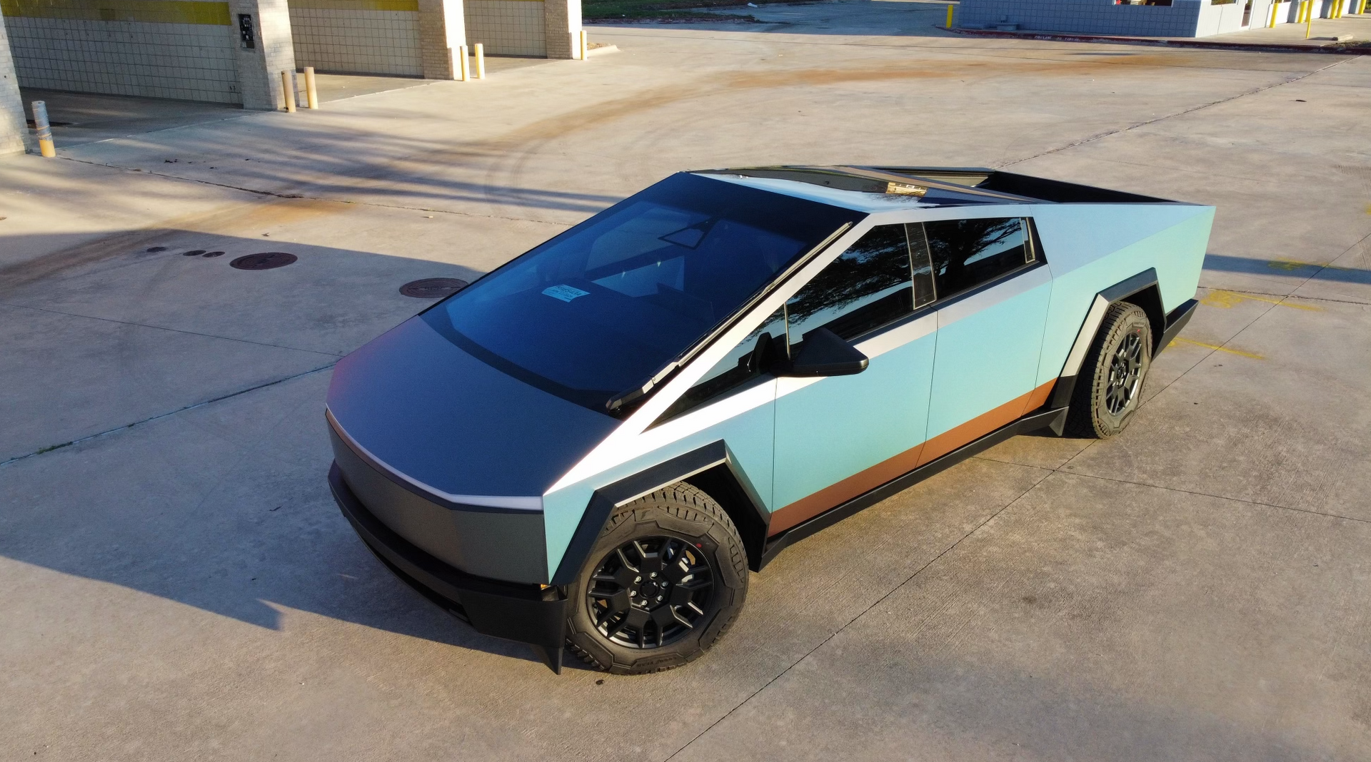 A tesla cybertruck is parked in a parking lot.