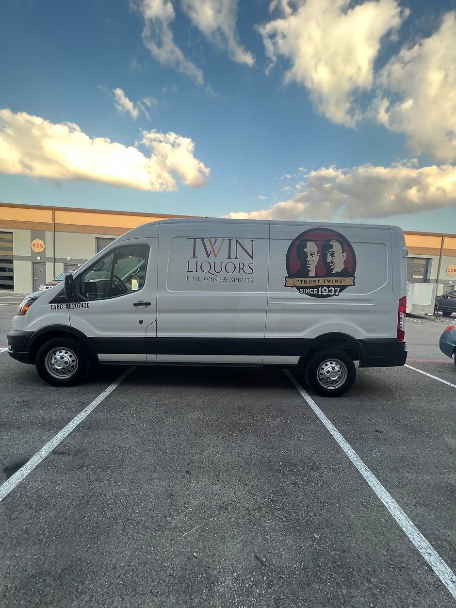 A white van is parked in a parking lot.