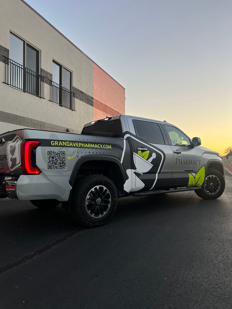 A truck is parked in front of a building.