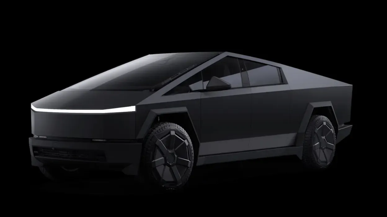 A black tesla cybertruck is sitting on a black background.