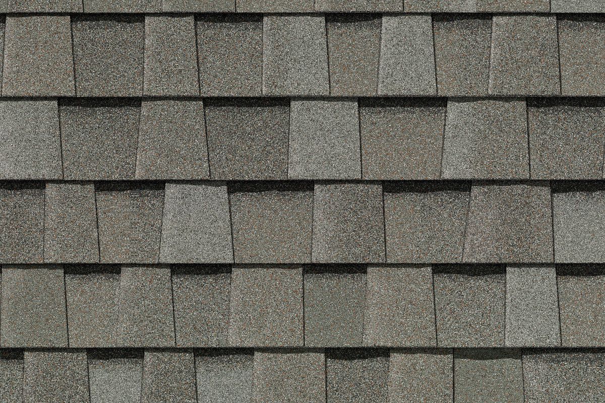 Gray asphalt shingles arranged in a staggered pattern, textured.