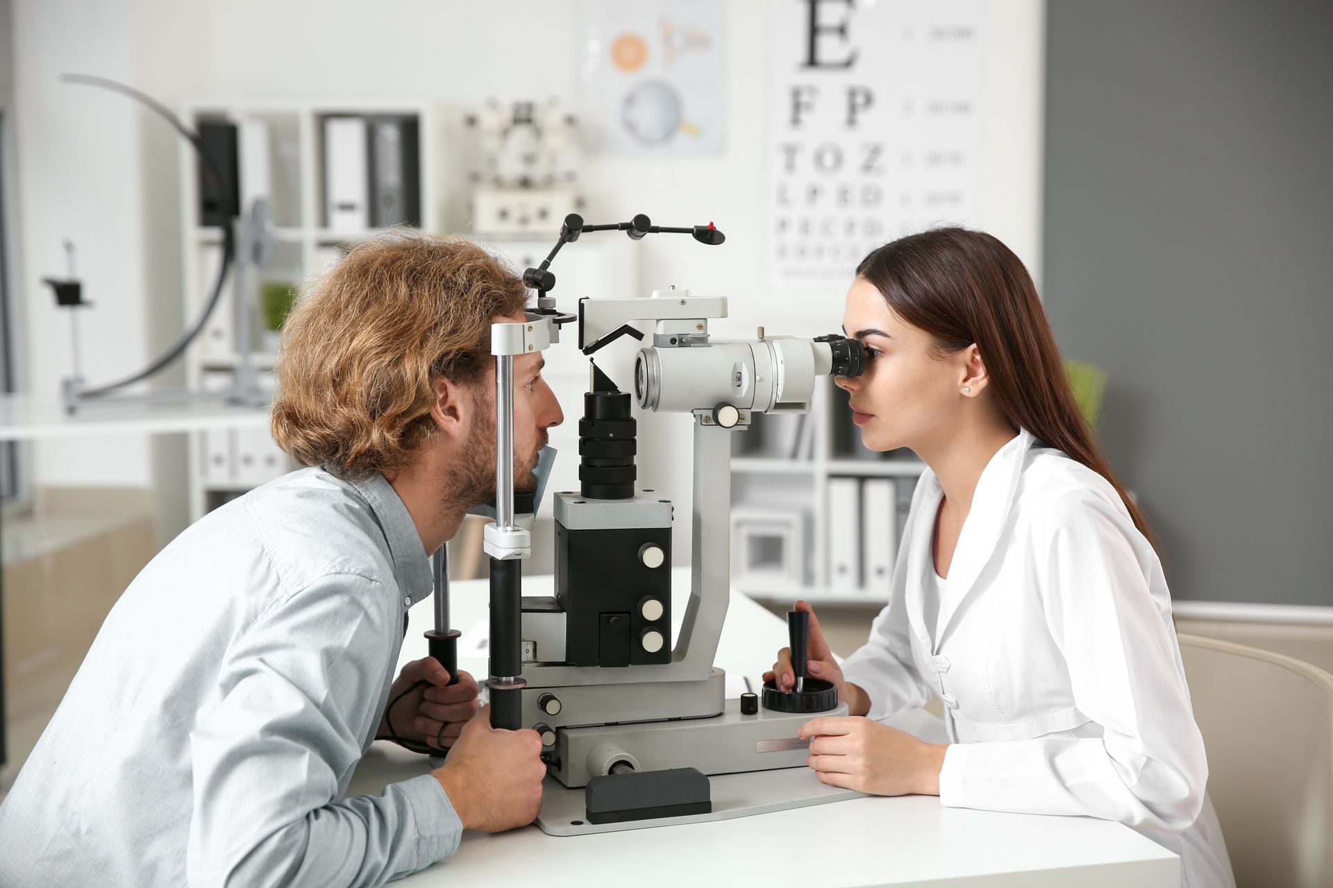 A doctor is doing an eye exam on a patient.