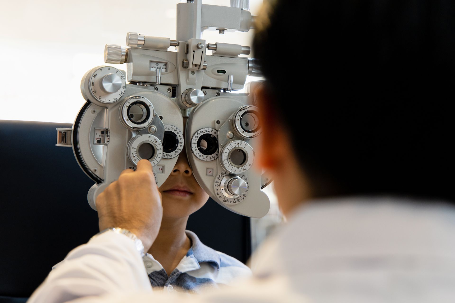 optometrists are examining pediatric patients' eyes with the Autorefractor.