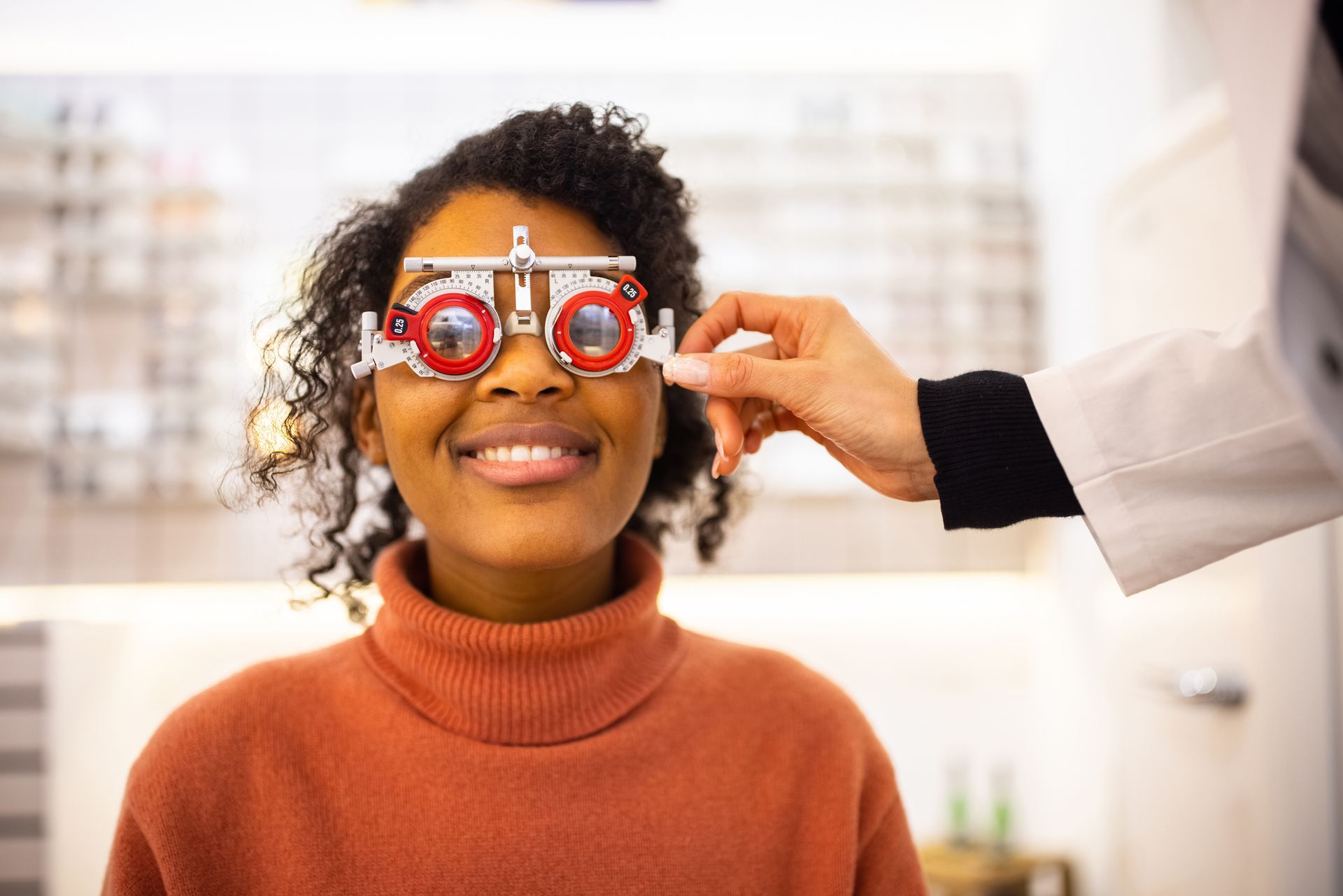 Young woman having eyesight test at optical store.