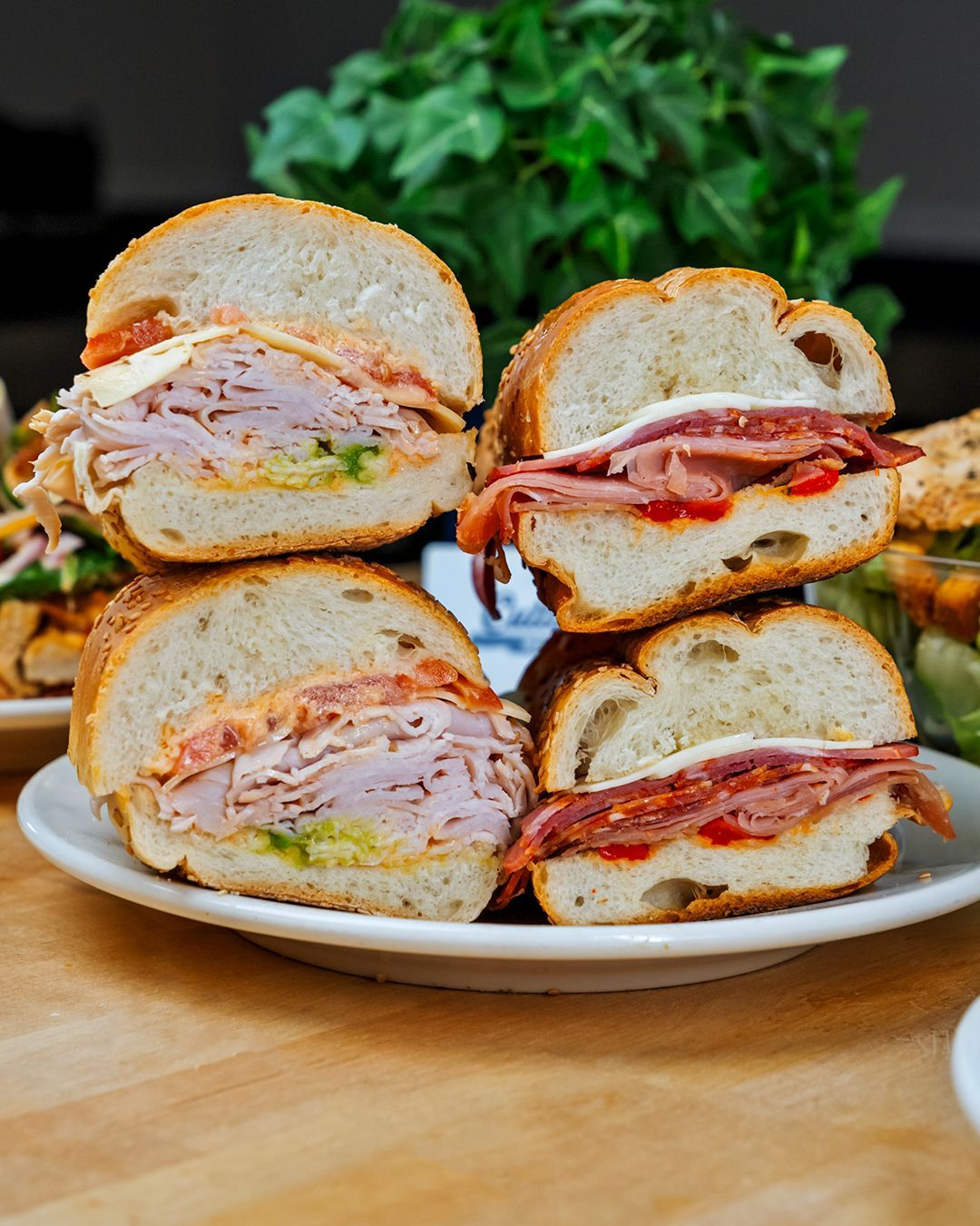 A plate of sandwiches stacked on top of each other on a table.