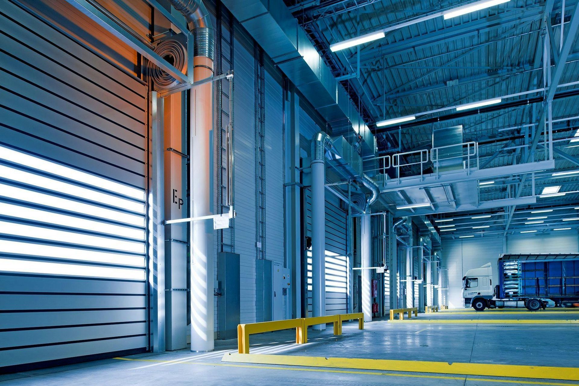 A large warehouse with a truck parked in the back