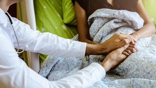doctor holding patients hands