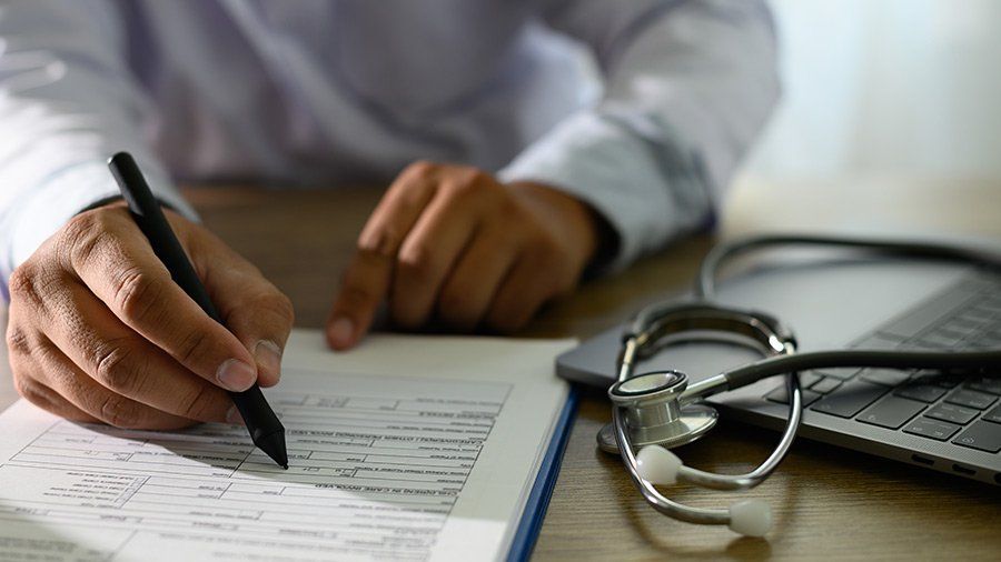 doctor filling out form