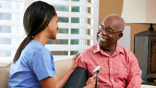 nurse taking a patients blood pressure