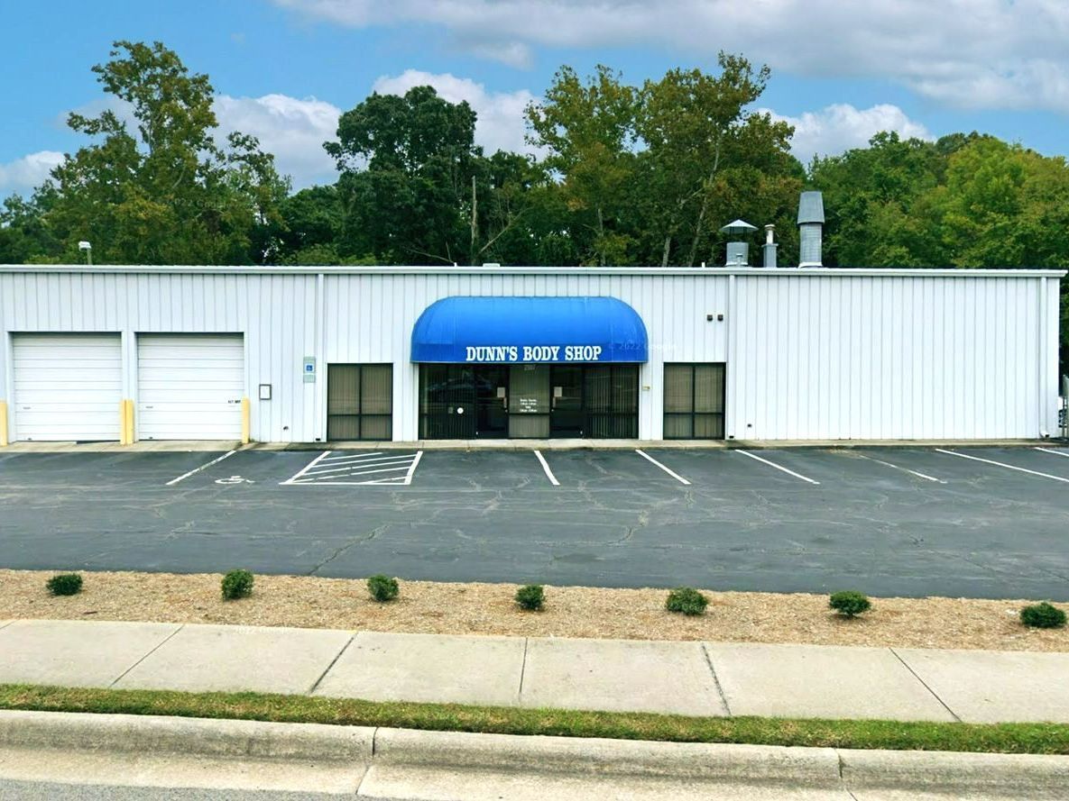 A white building with a blue awning that says baltimore