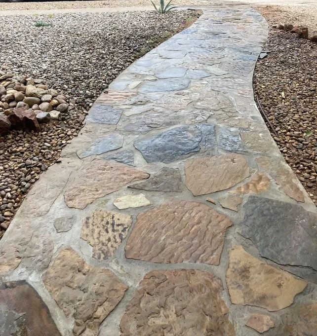 Curving stone walkway through a gravel desert landscape