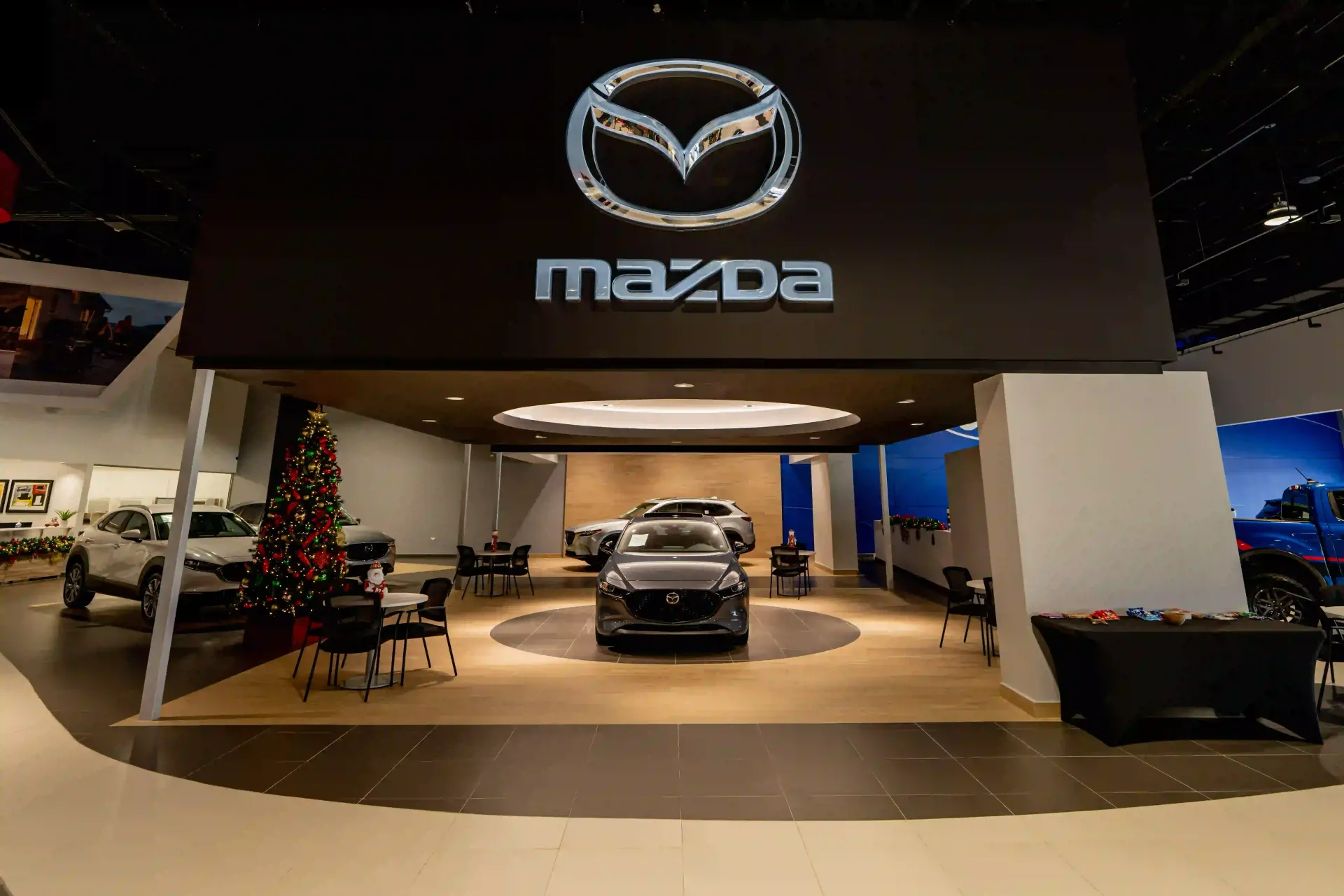 Mazda showroom with a car on display under a large Mazda logo