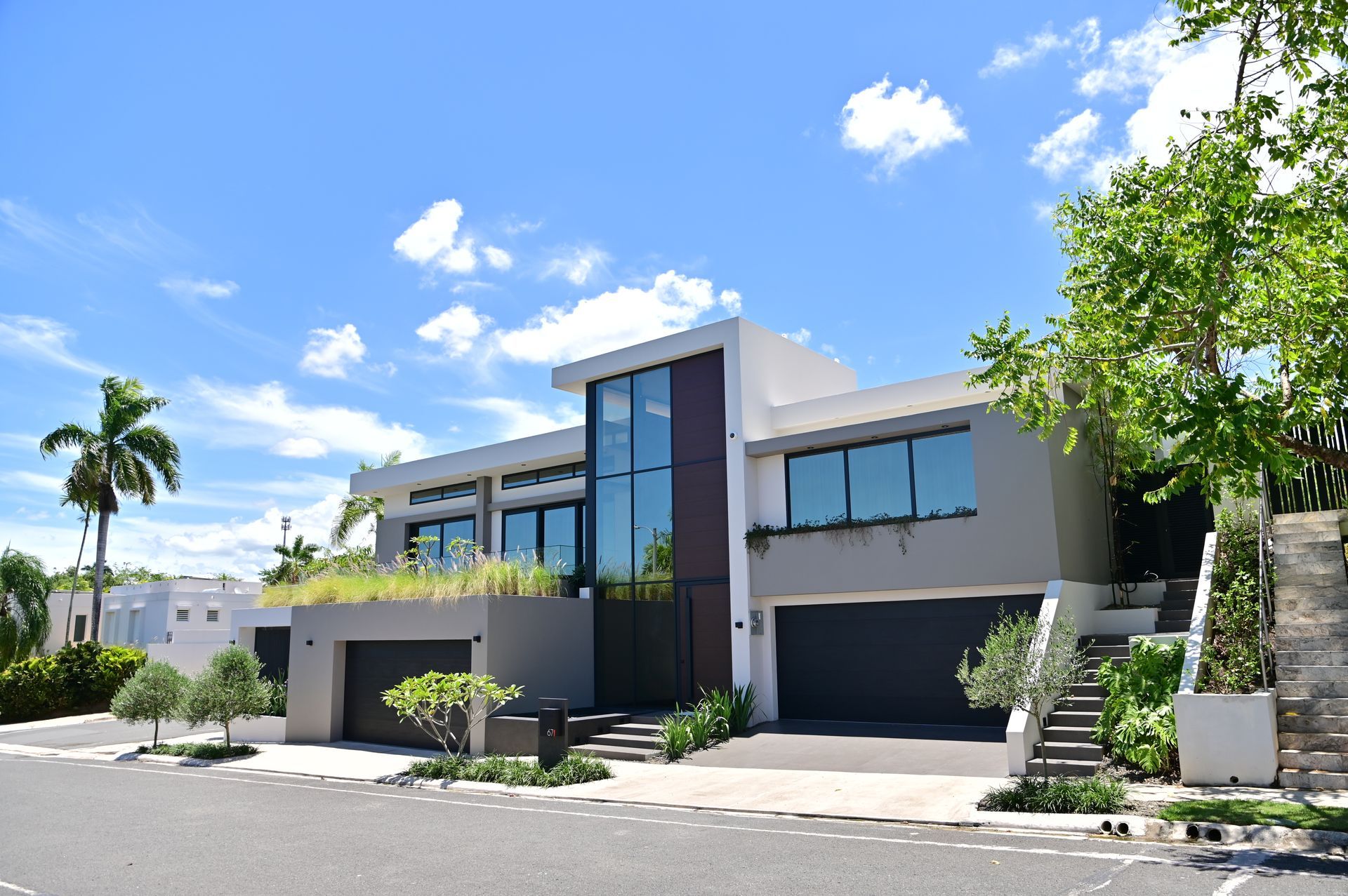 A large luxury home with a lot of windows and stairs in Puerto Rico, built by DEV Builders Group