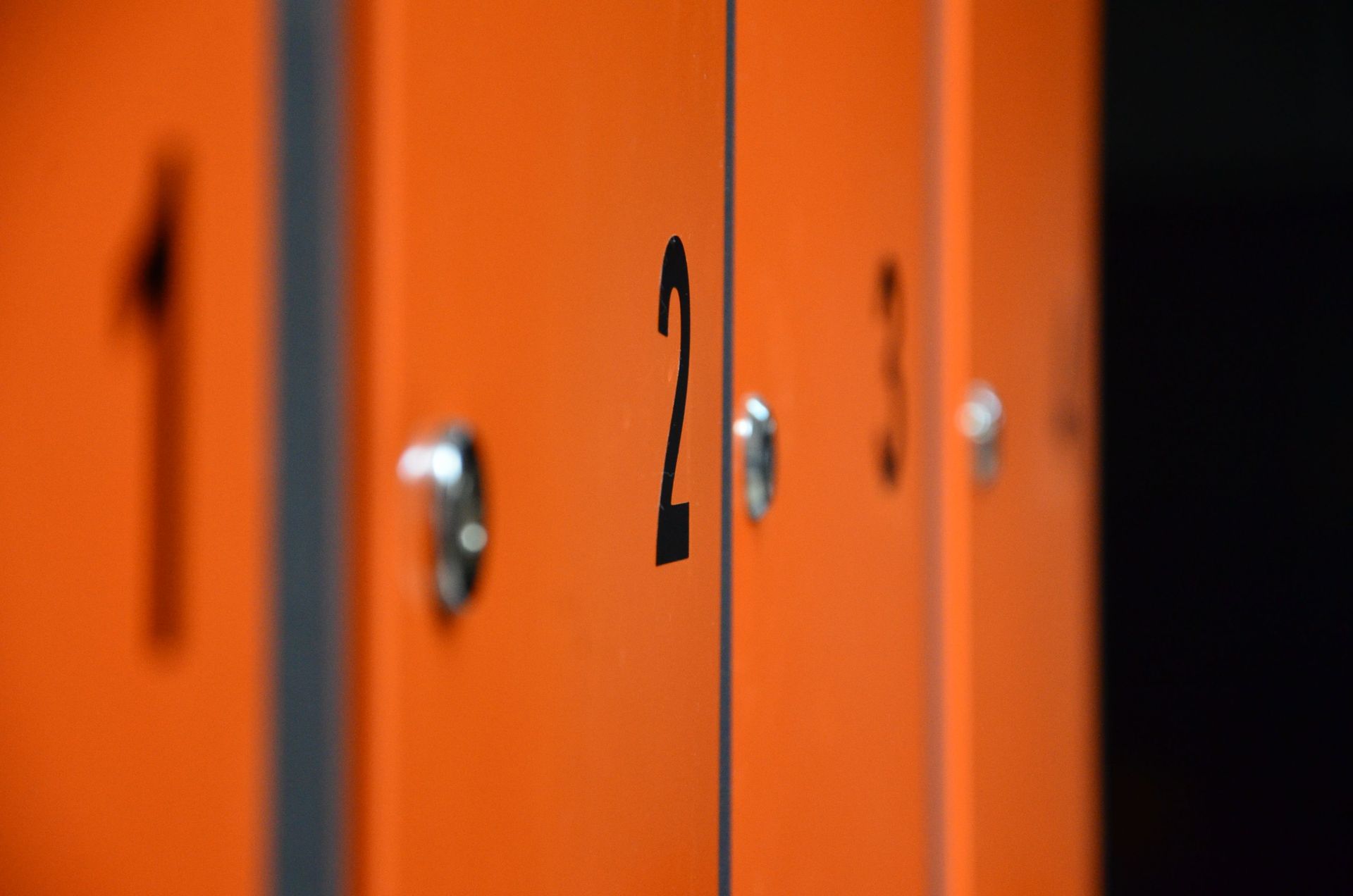 Orange lockers with the number 2 in a row, shallow focus