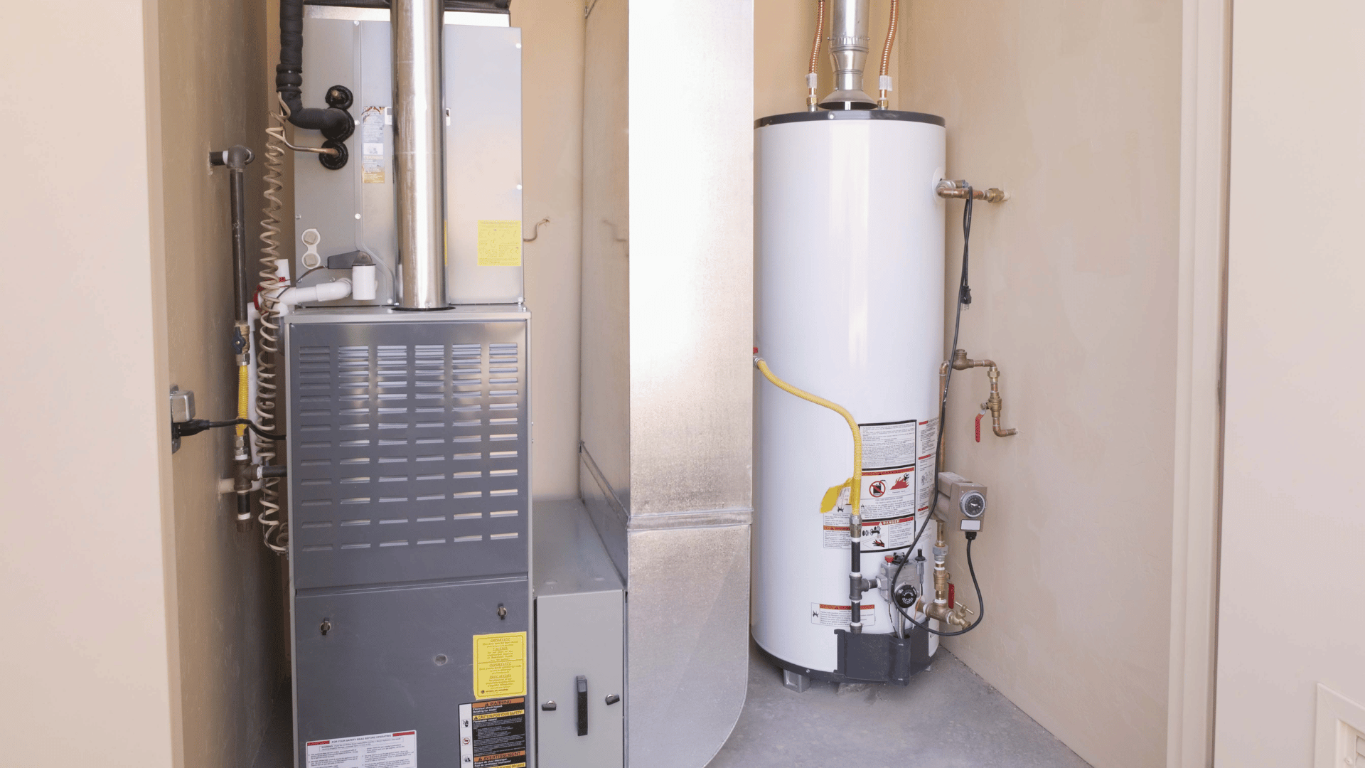 A room with a heater and a water heater in it.