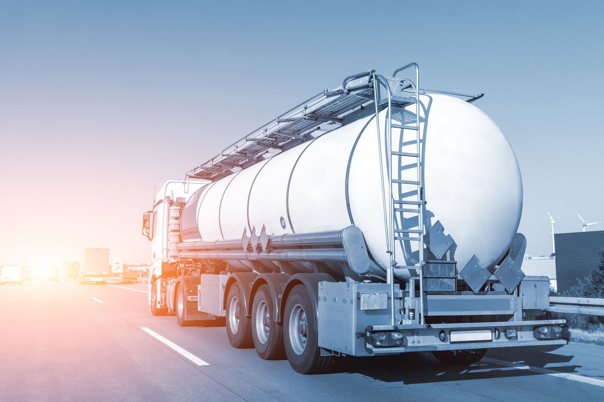 Tanker truck transporting cargo along a highway for commercial fuel distribution.