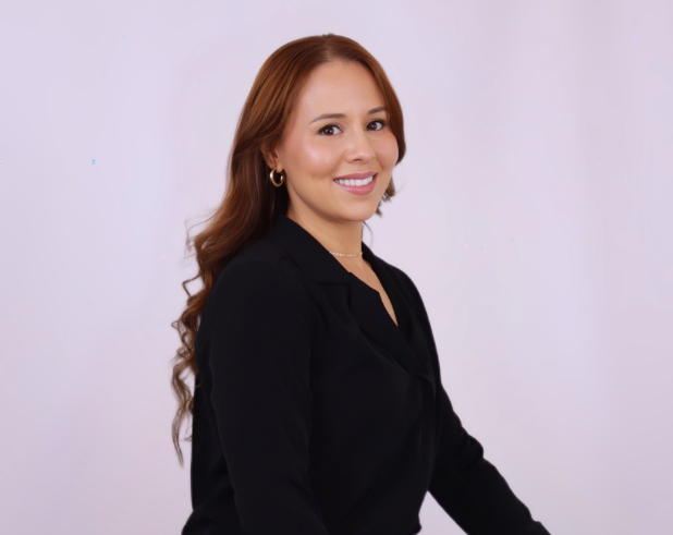 A woman in a black shirt is smiling for the camera