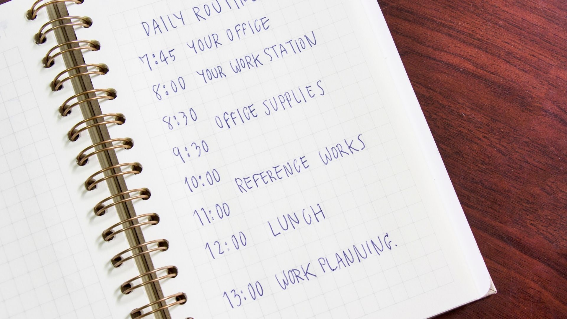 A spiral notebook is open to a page that says daily routine