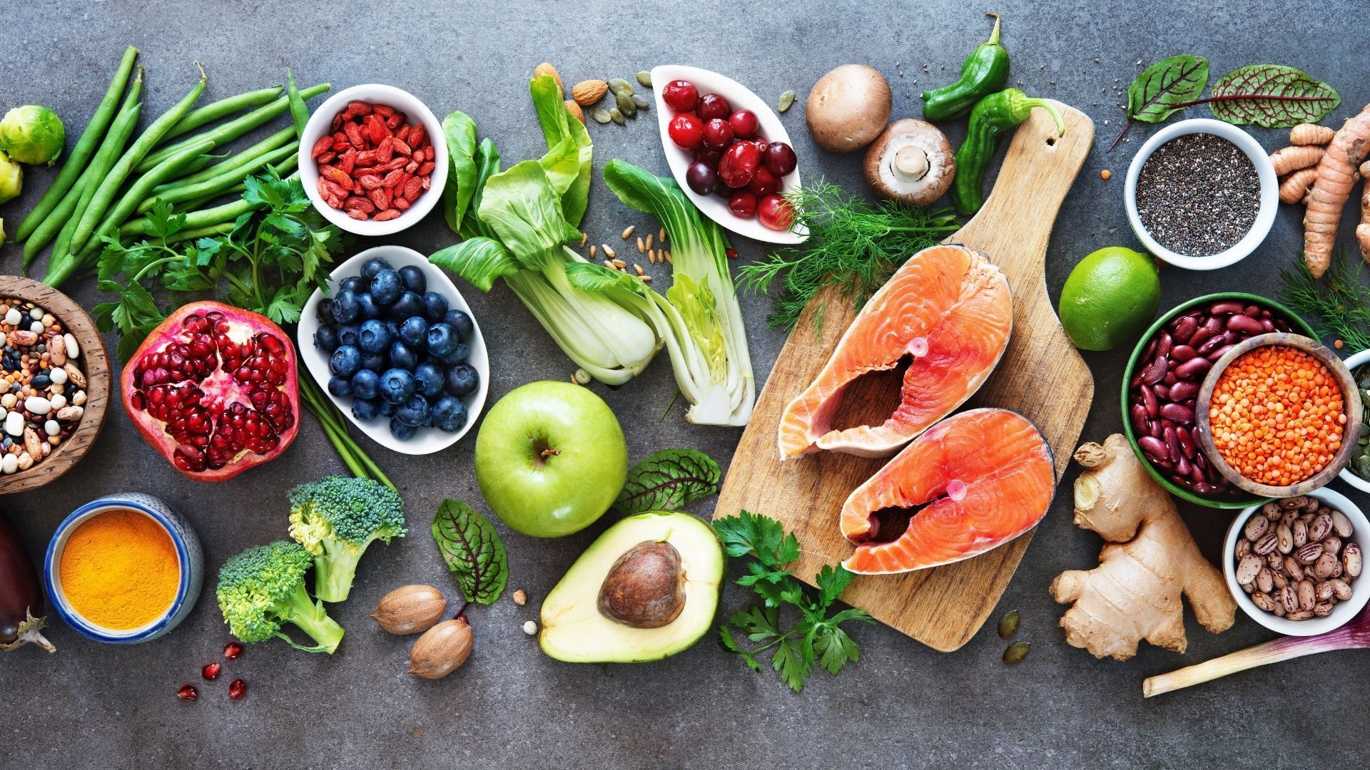 There are many different types of fruits and vegetables on the table.