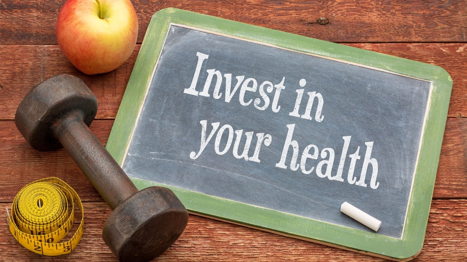 A chalkboard with the words `` invest in your health '' written on it.
