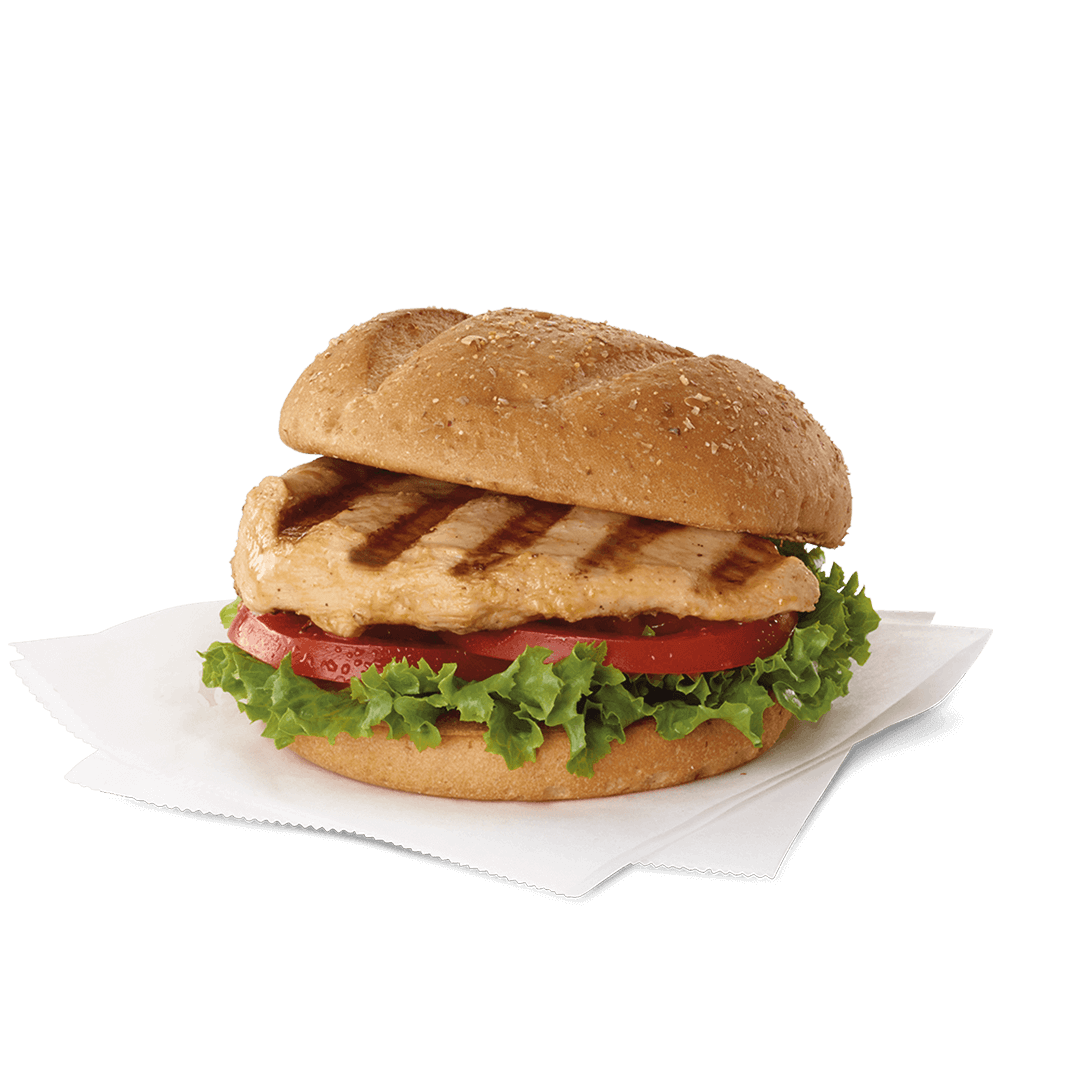A Chick fil A Macro, grilled chicken sandwich with lettuce and tomatoes on a bun on a napkin.