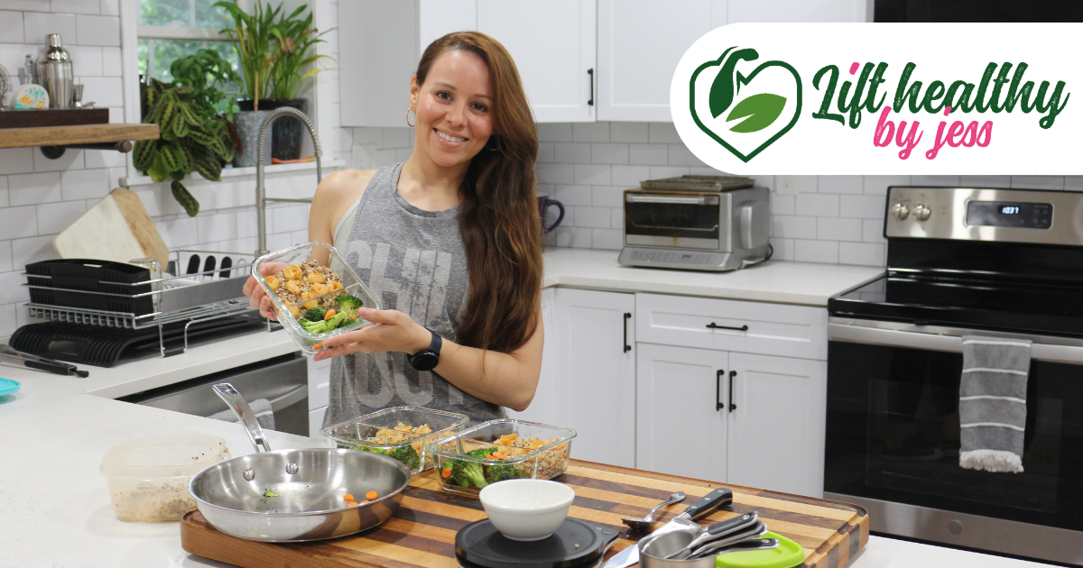 A woman is standing in a kitchen holding a bowl of food.