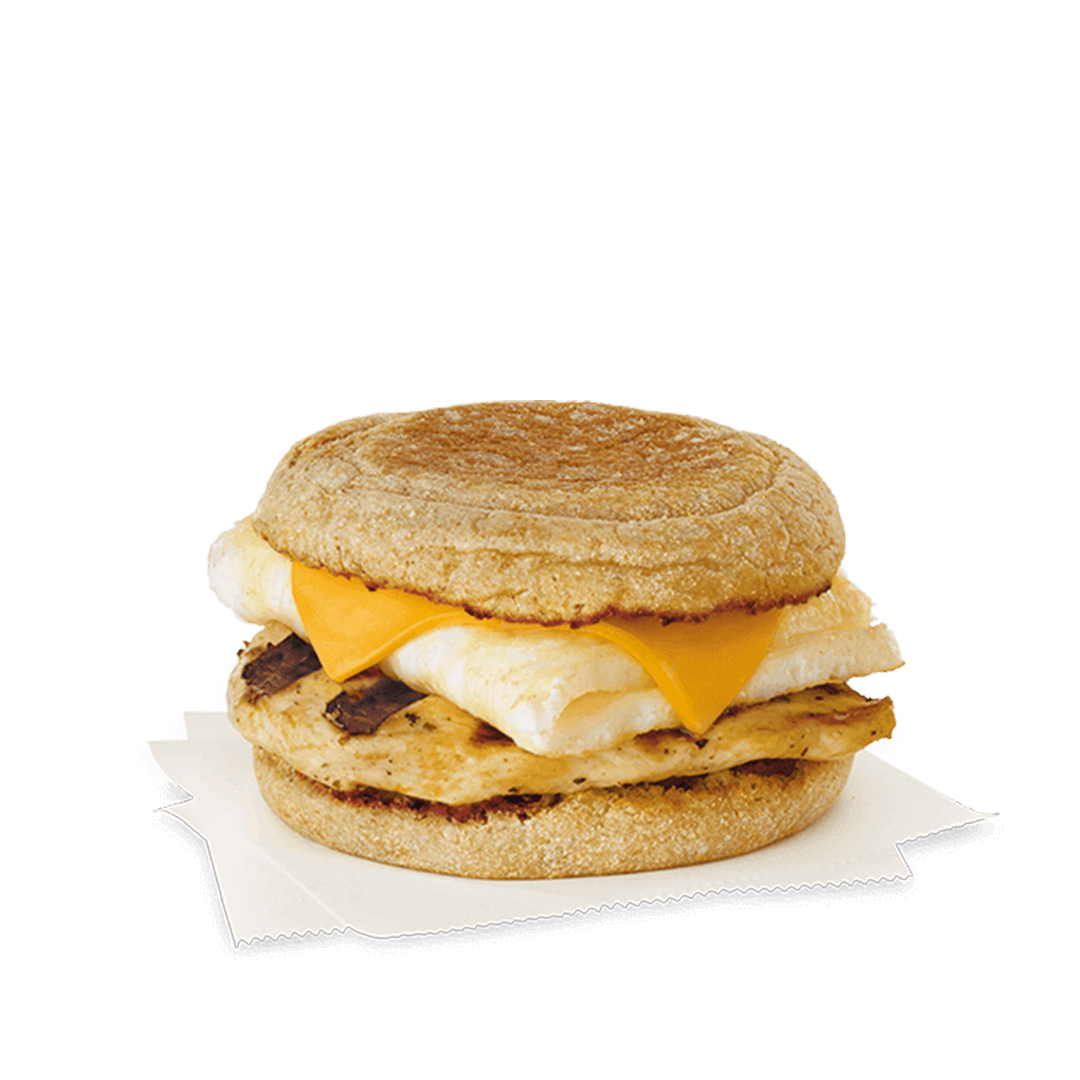 A close up of a breakfast sandwich on a muffin on a napkin. Chick fil A Macros