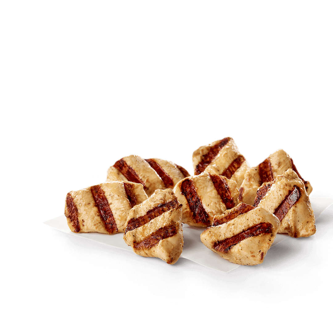 A pile of grilled chicken nuggets on a white surface. Chick fil A Macros