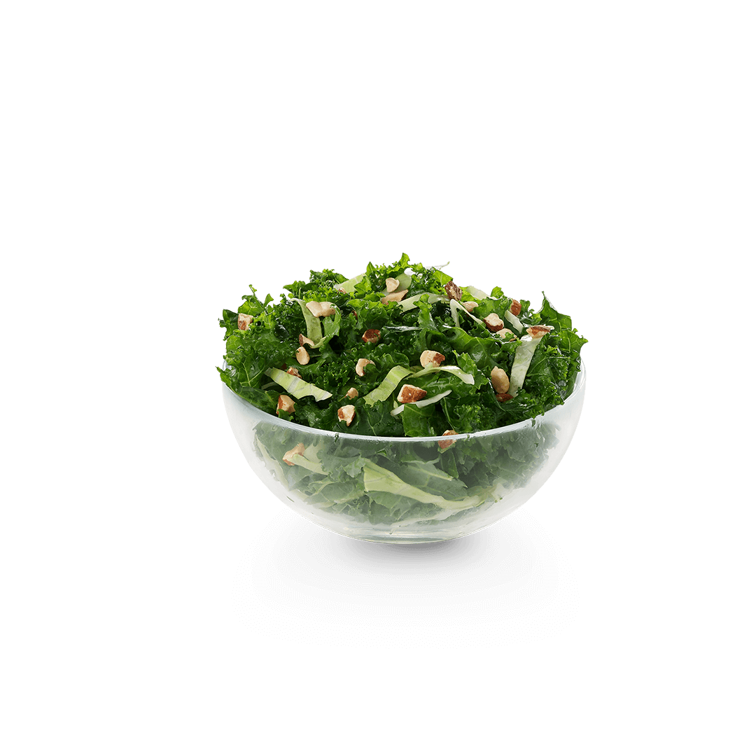 A salad in a glass bowl on a white background.
