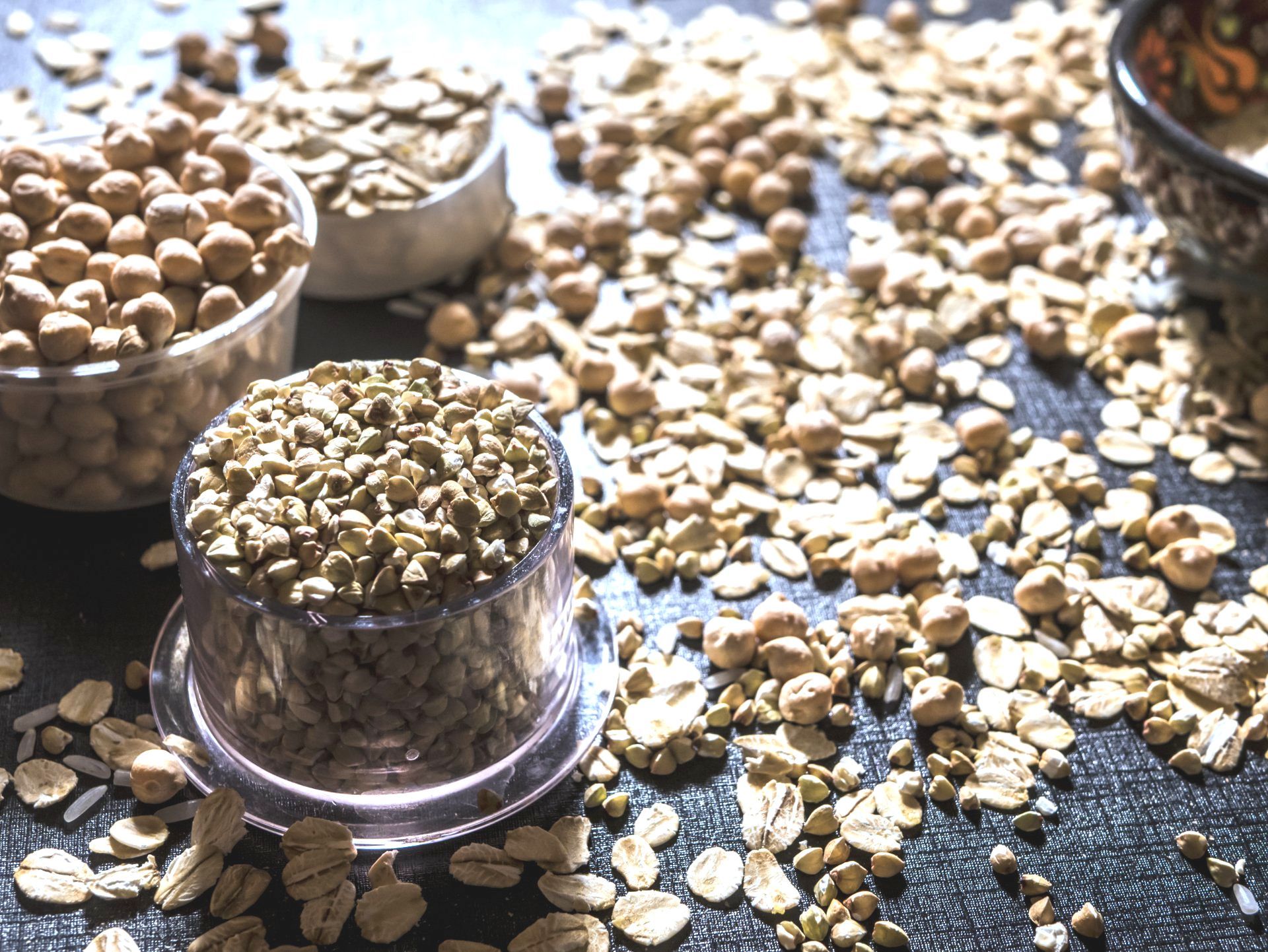 A table topped with bowls of nuts and oats.