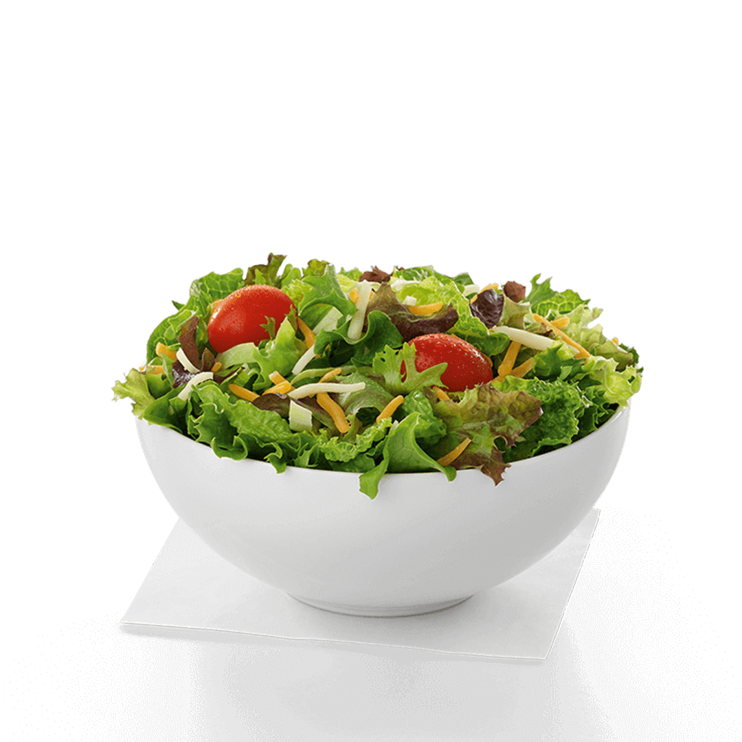 A salad in a white bowl on a napkin on a table. Chick fil A Macro healthier options